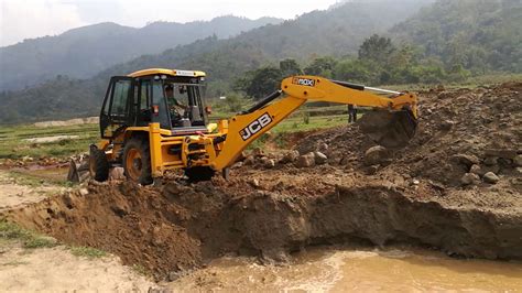 digging a pond with a skid steer|digging a pond with backhoe.